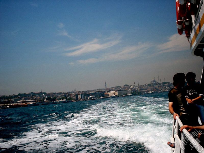 View of Eminonu coast, Beyazit Tower, Yeni Cami (Mosque) and Suleymaniye Mosque from the sea in Istanbul city of Turkey.
