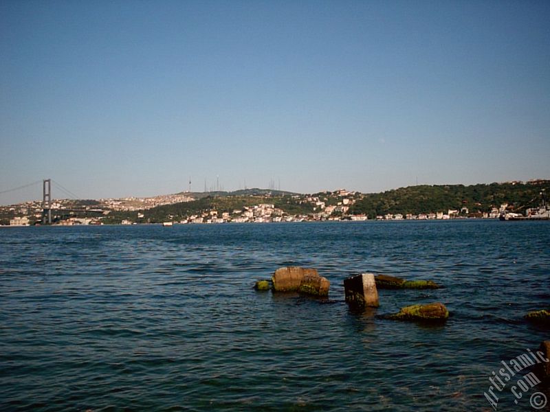 View of the Bosphorus Bridge, Camlica Hill and Uskudar-Beylerbeyi coast from a park at Besiktas shore in Istanbul city of Turkey.
